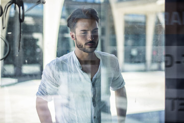 Fototapeta premium One handsome young man in urban setting in European city