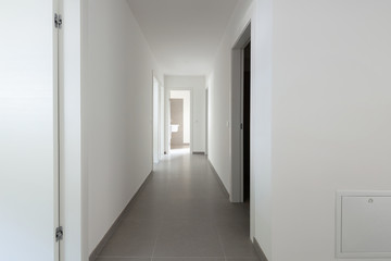 White corridor with many open doors