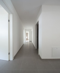 White corridor with many open doors
