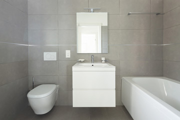 Modern bathroom with large tiles in newly built apartment