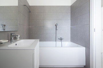 Modern bathroom with large tiles in newly built apartment