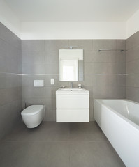 Fototapeta na wymiar Modern bathroom with large tiles in newly built apartment
