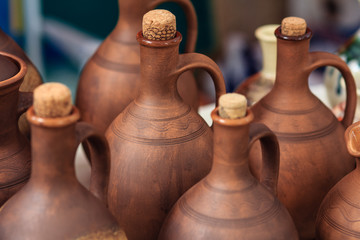 Fototapeta na wymiar Handmade clay products. Jars for wine and oil.