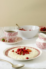 A useful breakfast of rice porridge with strawberry sauce served with tea.
