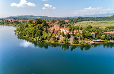 Fototapeta na wymiar Aerial view of Lake Varese and church of San Lorenzo of Biandronno, Italy