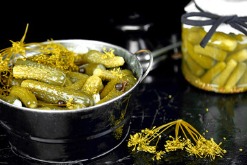 Canned cucumbers in a metal pan.
