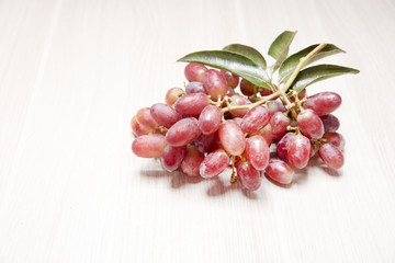 Red grapes on wooden floor