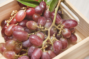 Red grapes in wooden boxes