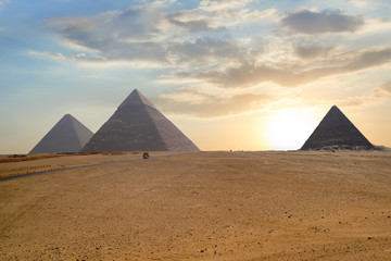 Fototapeta na wymiar Great pyramids in Giza valley during sunset. World famous landmark in Egypt.
