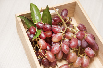 Red grapes in wooden boxes
