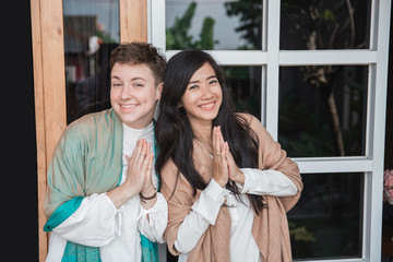 woman showing asian greeting gesture