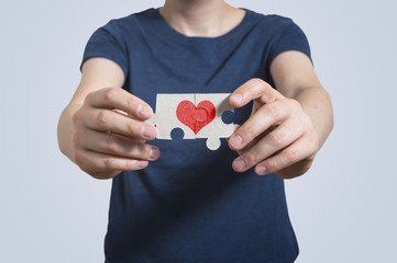 Pearson holding puzzles with red heart