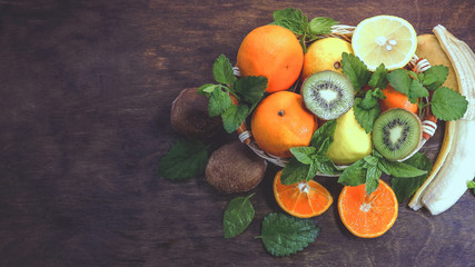 citrus fruits in a basket  on a wooden background