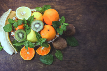citrus fruits in a basket  on a wooden background