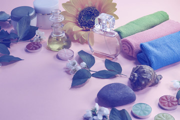 Obraz premium Beauty background with cosmetic products, bottle of perfume, leaves and jasmine blossom on toned background. spa. top view, flat lay. desktop, copy space.