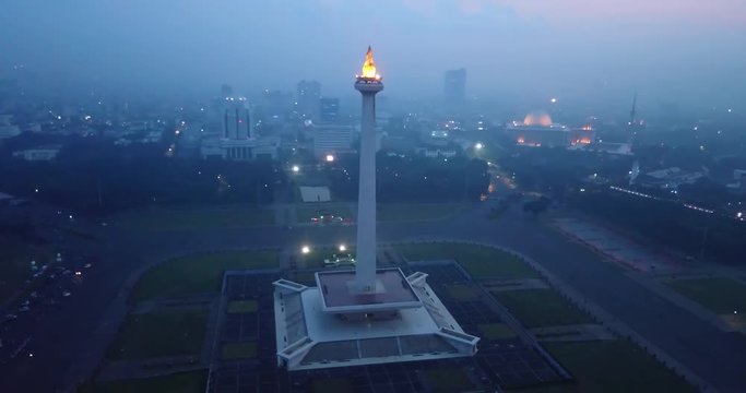 JAKARTA, Indonesia - May 30, 2018: Beautiful aerial footage of National Monument at night from a drone in Merdeka Square, Jakarta city. Shot in 4k resolution