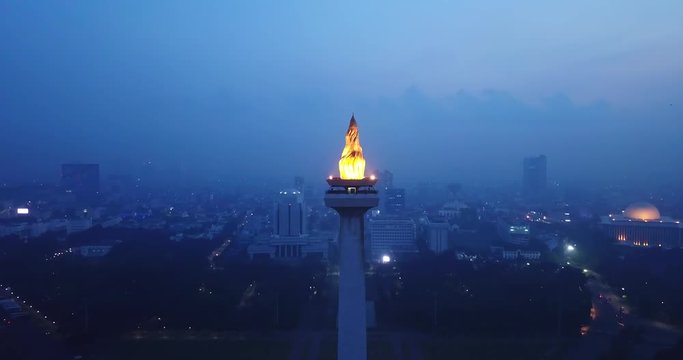 JAKARTA, Indonesia - May 30, 2018: Beautiful aerial scenery of National Monument at night in Central Jakarta, Indonesia. Shot in 4k resolution from a drone flying backwards