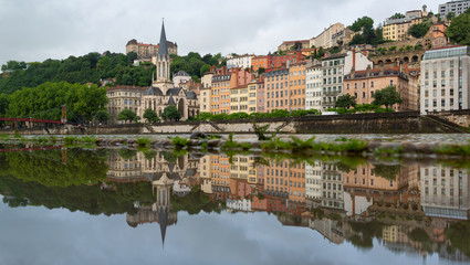 Fototapeta na wymiar The historical buildings of UNESCO world heritage site Vieux-Lyon reflected in a puddle. Lyon, France.