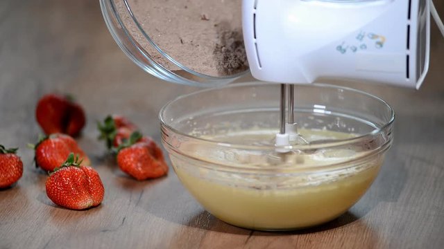 Mixing Cocoa Powder, Flour and Beaten Eggs. Making Chocolate Layer Cake.