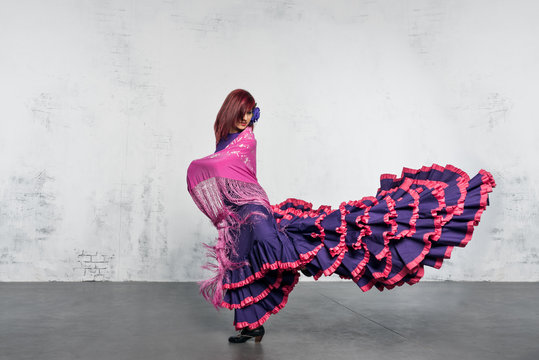 Flamenco dancer in action with the typical Spanish dance costume.