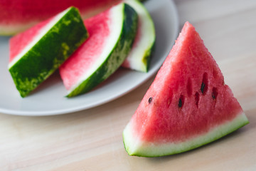 Sliced fresh watermelon on wooden background closeup