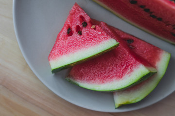 Sliced fresh watermelon on wooden background closeup