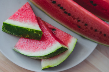 Sliced fresh watermelon on wooden background closeup