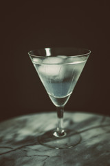 cold drink in martini glass with black background
