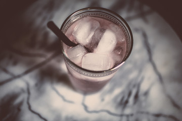 pastel colored cocktail glass on marble table