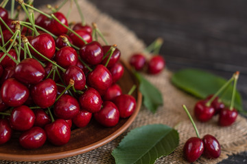 Tasty juicy sweet cherry on a wooden background. It can be used as a background