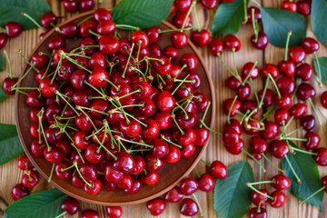 Tasty juicy sweet cherry on a wooden background. It can be used as a background