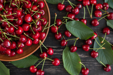 Tasty juicy sweet cherry on a wooden background. It can be used as a background