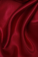 Smooth elegant red silk or satin luxury cloth texture as abstract background. Luxurious valentines day background design