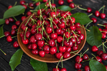 Tasty juicy sweet cherry on a wooden background. It can be used as a background