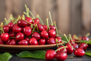 Tasty juicy sweet cherry on a wooden background. It can be used as a background