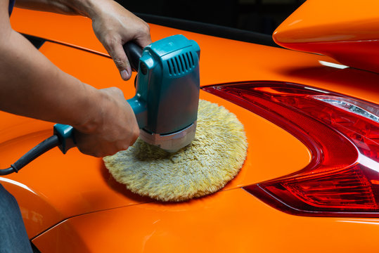 Fototapeta Car detailing series: Polishing orange sports car