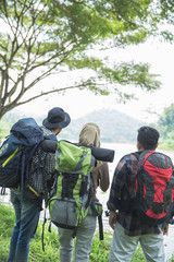 people in the forest with backpack hiking