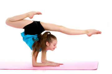 A gymnast performs an exercise stance on her forearms.