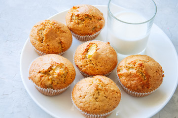 Gluten free almond flour muffins with apples in a bowl on a white stone background.