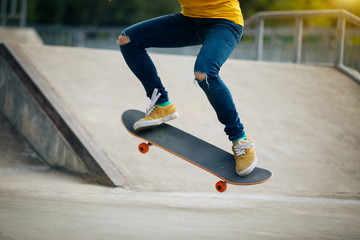 skateboarder skateboarding on skatepark ramp © lzf