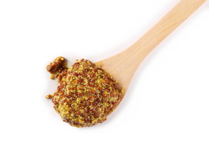 French mustard spreading with wooden spoon, isolated on white background and texture, top view