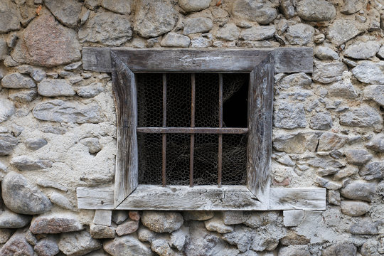 rustic window in a stone wall