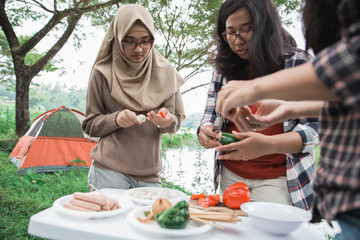 preparing food with skewers during outing