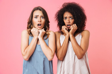 Two scared young girls dressed in summer clothes