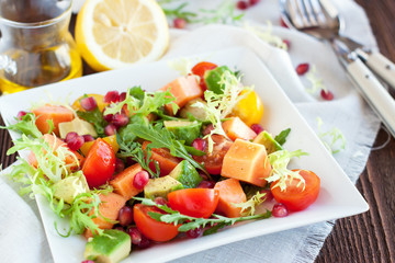 Healthy salad with papaya, avocado, tomatoes