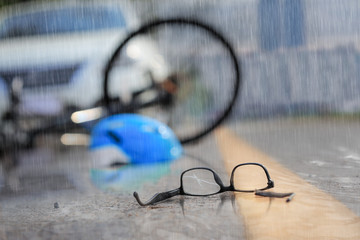 Accident car crash with bicycle on road in rainy weather
