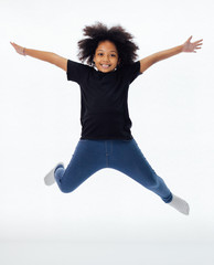 Happy and fun African American black kid jumping with hands raised isolated over white background