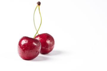 Sprig of cherries on a white background.