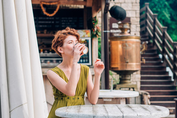 Beautiful woman drinking coffee at cafe.