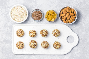 Raw vegan healthy dessert, date and nuts bliss balls, ingredients. Top view, space for text.